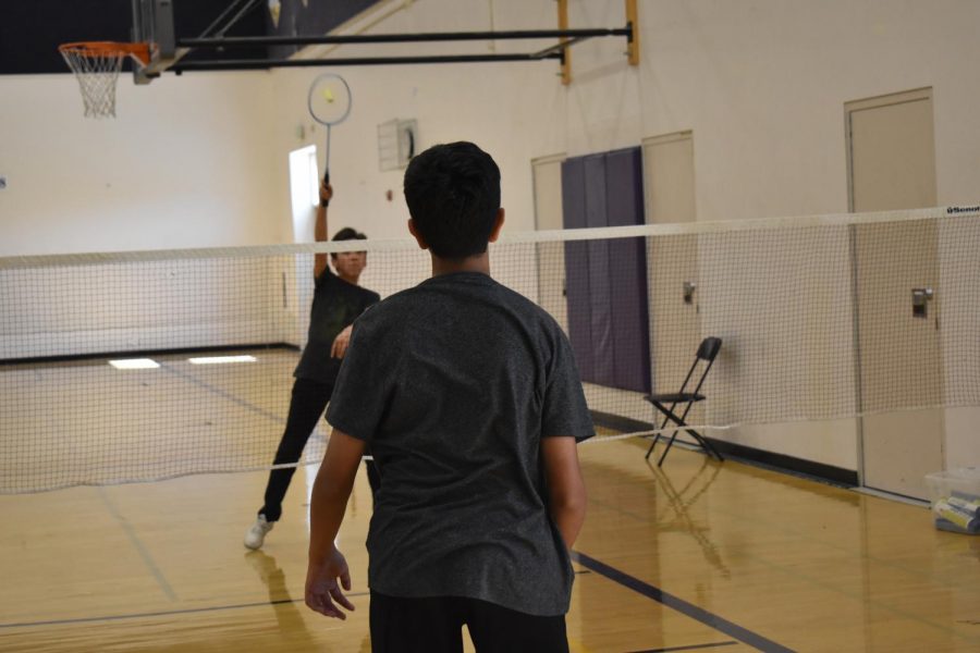 Freshman Samuel Choi returns a hit during Badminton Clubs lunch open gym.
