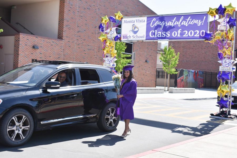 Senior Janani Kumar poses for a photo by her car.