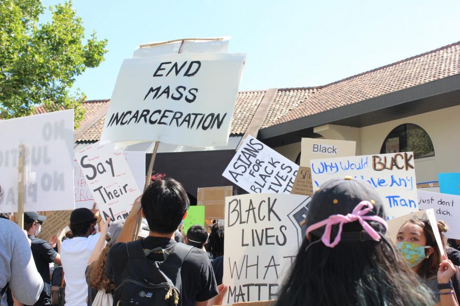 Signs held at the demonstration as protestors chant.