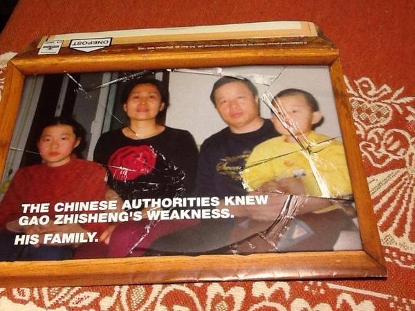 A picture of the Gao family is cased in a broken frame. The Gao family was once together until Peter Gao, Geng He and Grace Gao moved to America in 2009. Used with permission