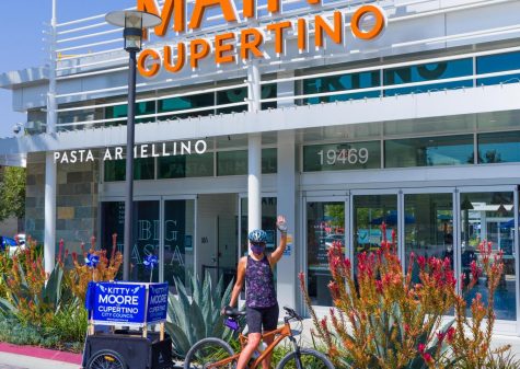 Picture: Moore waves as biking in front of Cupertino Main Street.