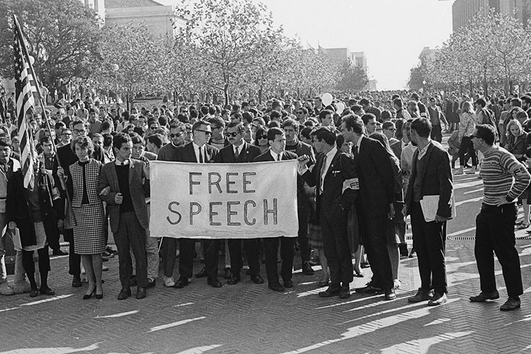 A+group+of+people+bring+Free+Speech+signs+to+a+University+Hall+on+November+20%2C+1964