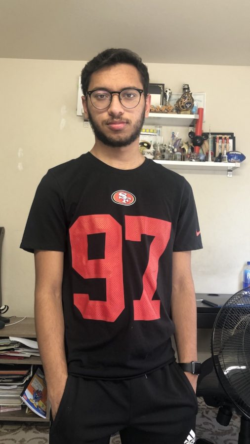 Senior Bassam Malik poses with his San Francisco 49ers jersey featuring defensive end Nick Bosa’s number.