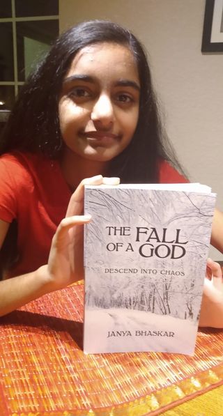 Janya Bhaskar poses with a copy of her debut novel The Fall of a God // Photo credit Preeta Raman