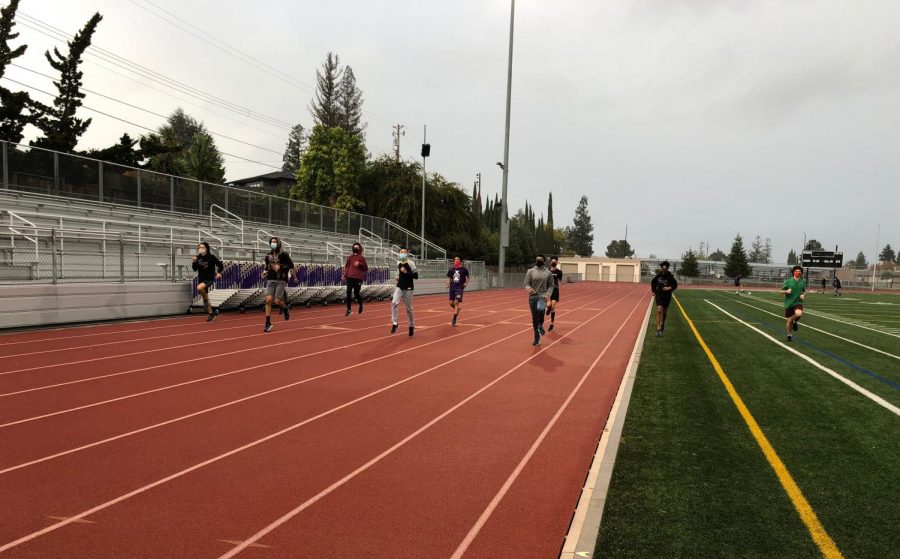 The male runners on the Cross Country team finish their drills in the rain, wearing masks and practicing social distancing. Flatow often gives runners inspirational speeches about running in bad weather, emphasizing the concept of grit, popularized by Flatow’s acquaintance and professor Angela Duckworth. 