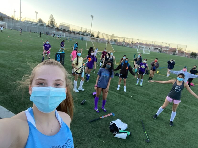 The+Varsity+and+JV+Girls+Field+Hockey+teams+take+a+picture+during+their+practice.+Photo+by+Charlotte+Dingli+%7C+Used+with+Permission