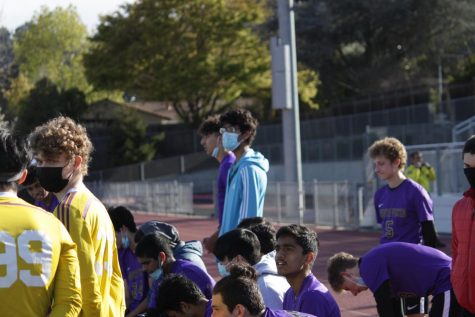 The MVHS Boys Soccer team huddles together after the game, preparing for a debrief from coach Pancho Tzankov and junior Edin Kraja. 