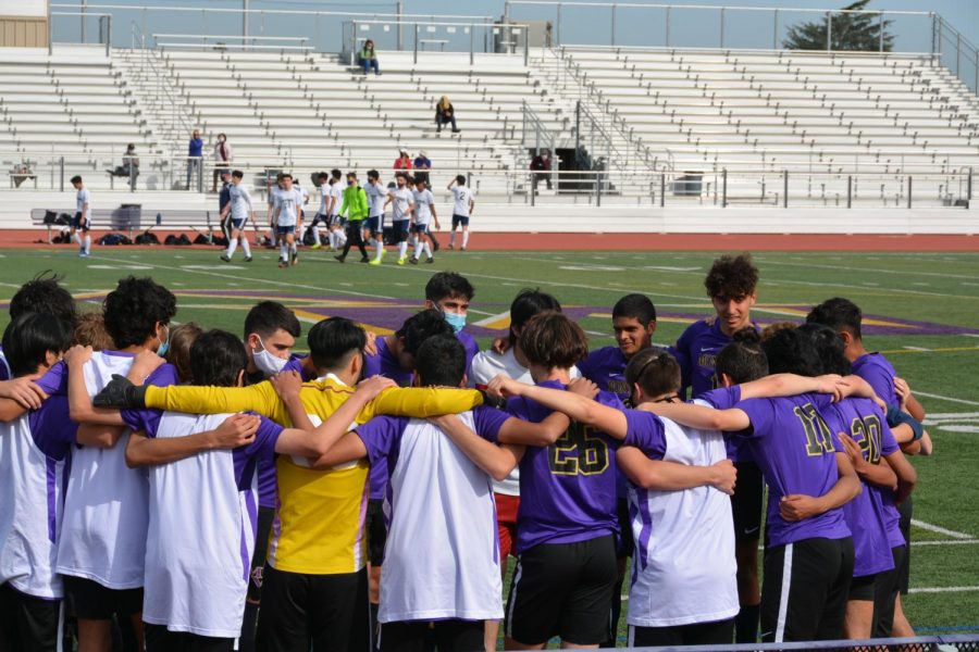 Varsity Boys Soccer players share a team huddle following a game.