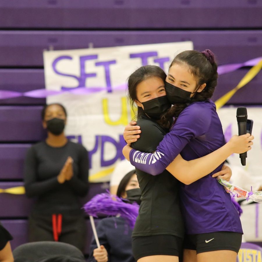 Junior Sydney Su and senior Marissa Jensen embrace in a tight hug. The four seniors were given speeches and gifts from the juniors before the start of the game.