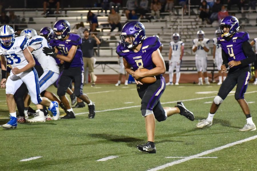 Junior Greyson Mobley runs with the ball after senior Prathmesh Modi passes it to him.