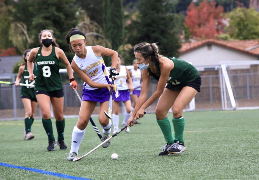 Senior and captain Ashley Twu attempts to make her way around an opponent from HHS.