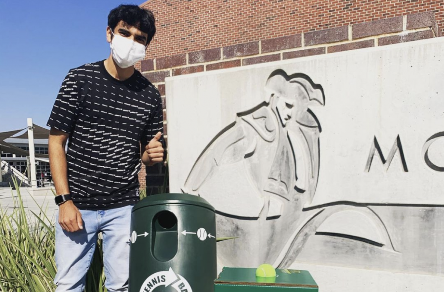 Junior Rohin Inani poses next to his two recycling bins for discarded tennis balls.