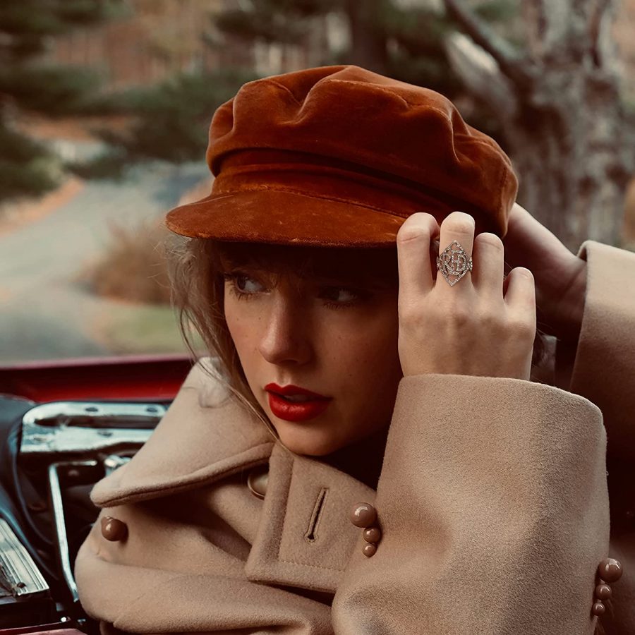 The album cover features Taylor Swift sitting in a red Chevrolet Cabriolet and wearing a red hat, establishing the significance of the color 