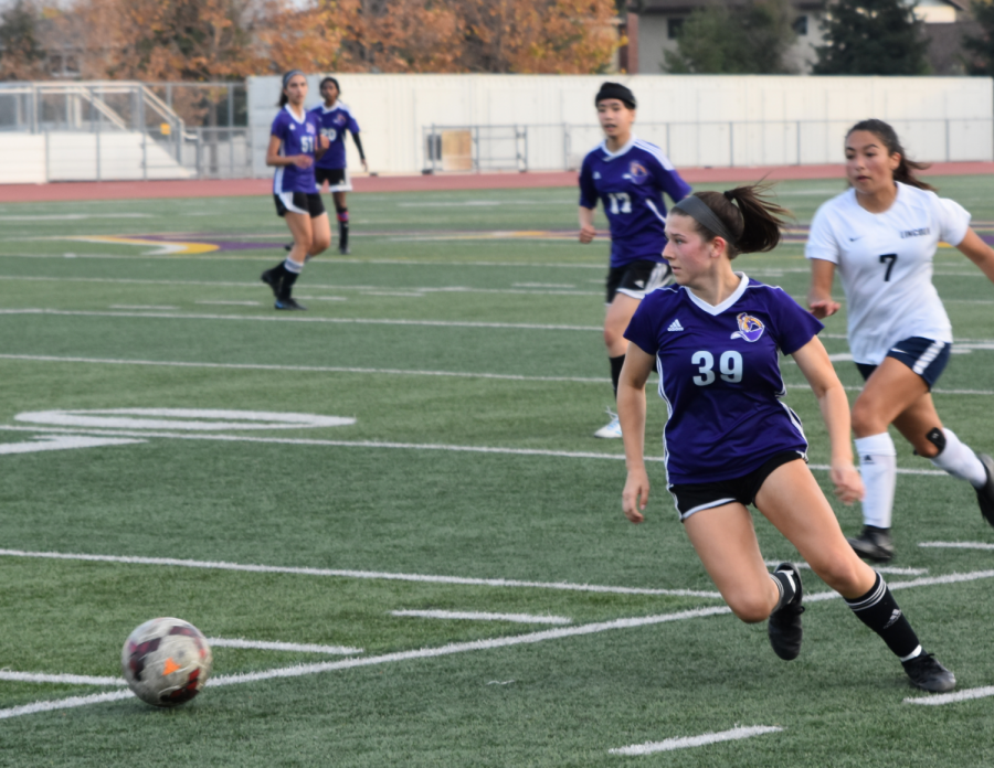 Freshman Maya Gallo sprints towards the ball as she gauges the field to see if any teammates are open.