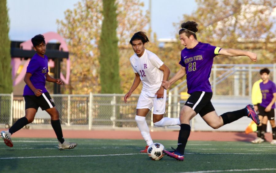 Senior and captain Mikey Tzankov dribbles the ball past an opponent from ARHS. 