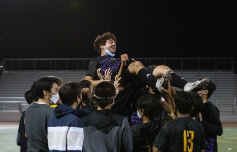 The team raises senior Remy Haghighi in a celebratory cheer after winning the game against Cupertino High School 4-1.