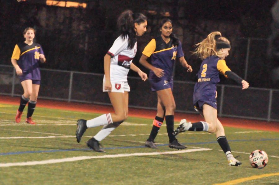 Sophomore Grace Knaff clears the ball after gaining possession.