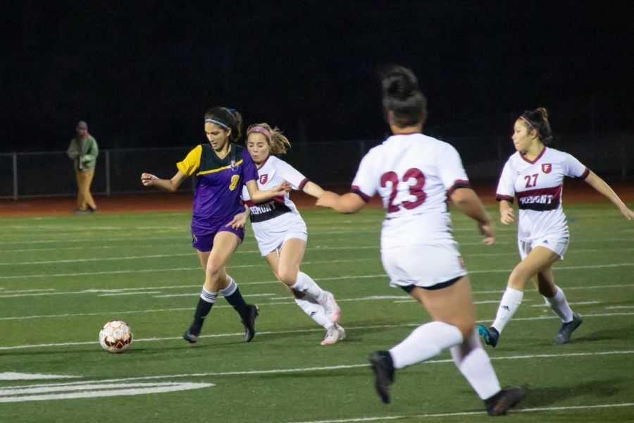 Sophomore Grace Knaff clears the ball after gaining possession.