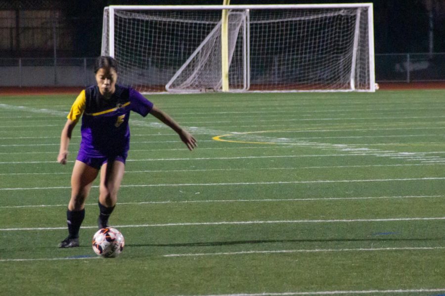 Junior Justine Garcia takes a freekick just outside of the box after a counterattack was disrupted by a foul. 