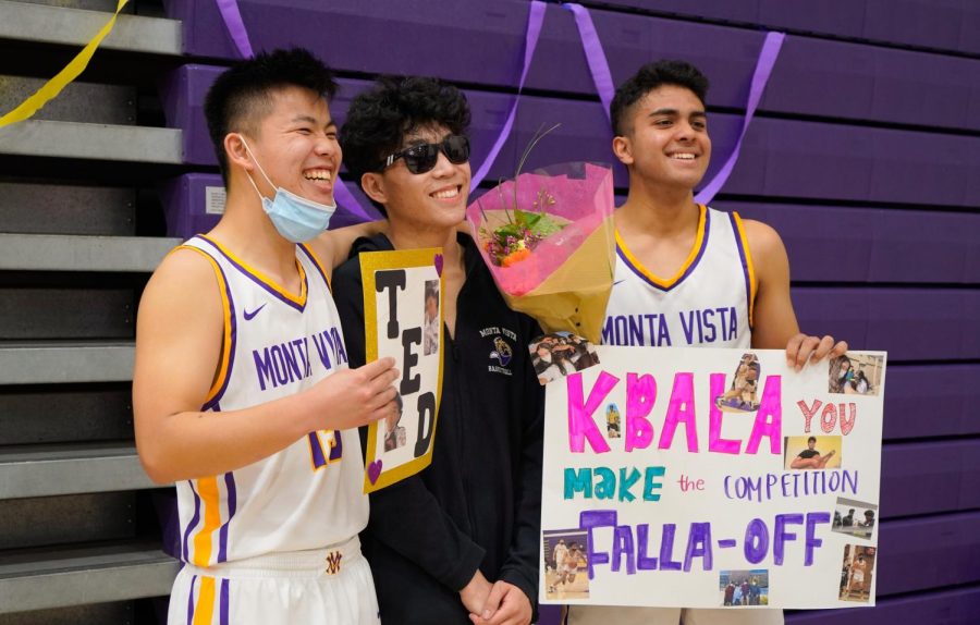 Seniors Theodore Zhang and Keshav Balaji hold up their posters while posing for a picture with junior Austin Hwang. Friends and family created posters for the two graduating seniors to celebrate their final home game. 
