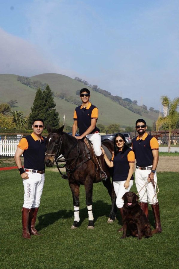 Sophomore Aditya Sharma poses with his family, who are all wearing customized Ralph Lauren polo uniforms.