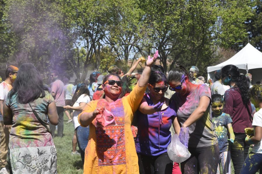 Attendees of the Memorial Park Holi celebration throw color in the air. Colored powder is a key tradition that is followed during the celebration of Holi.