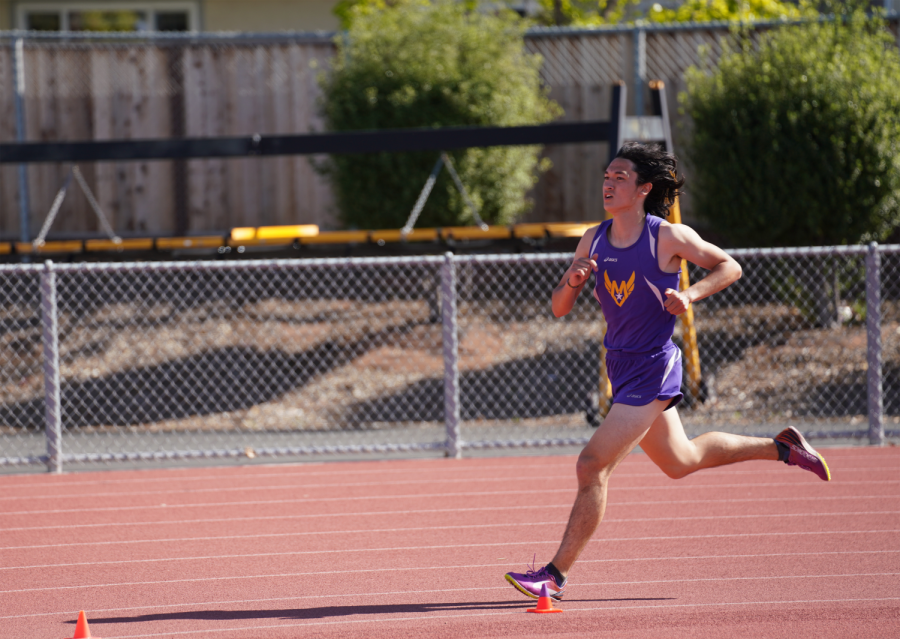 Senior Andrew Cole runs down the track during a track meet. 