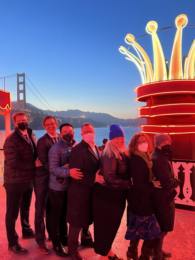 Photo Courtesy of Bonnie Belshe | The chaperones for 2022s combined prom pose on the deck of the ship where prom takes place as they pass by the Golden Gate Bridge