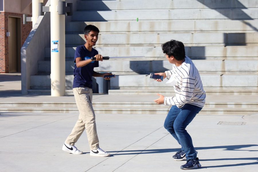 With scripts in hand, seniors Jaewon Shim (right) and Darpan Singh (left) practice their lines for the skit. 