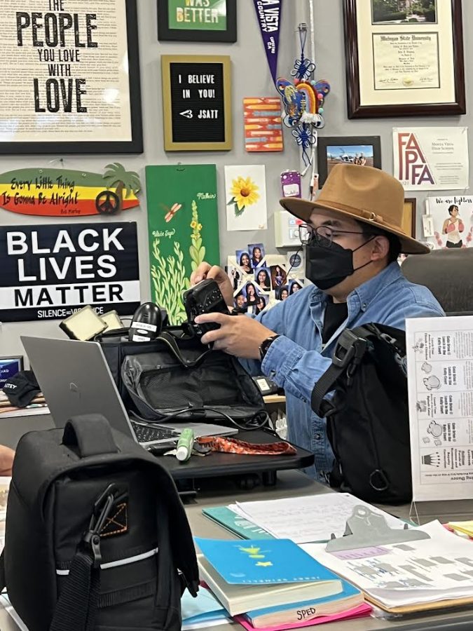 Kenneth Gan checks out a camera in his first period yearbook class. Photo by Arti Gnanasekar 