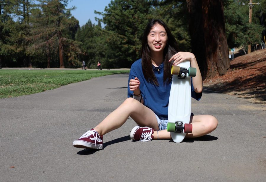 Senior Ting Chang poses with her skateboard.