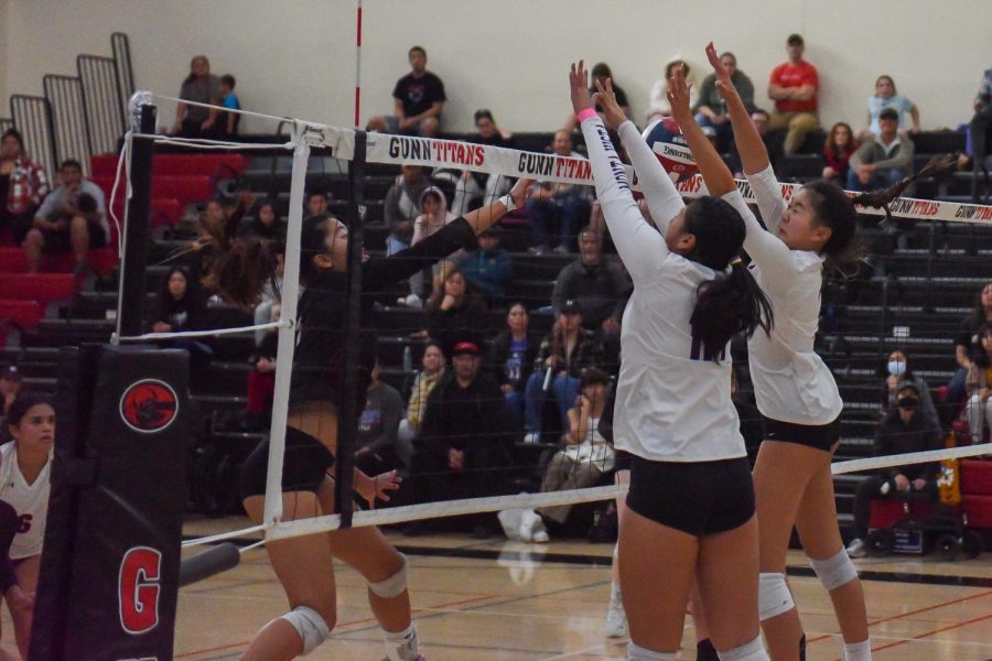 Sophomores Kiana Mark (left) and Samantha Tong (right) block a spike from AHS. Photo by Darpan Singh