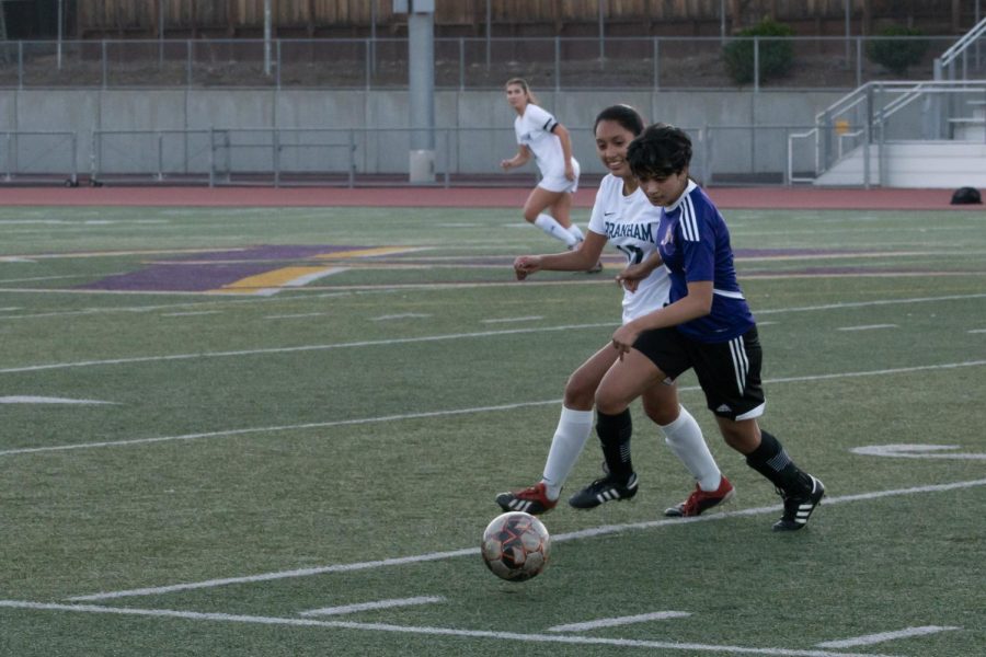 Senior Diya Balakrishnan dribbles the ball around a BHS defender during the second half to advance up the field. Photo by Kalyani Puthenpurayil