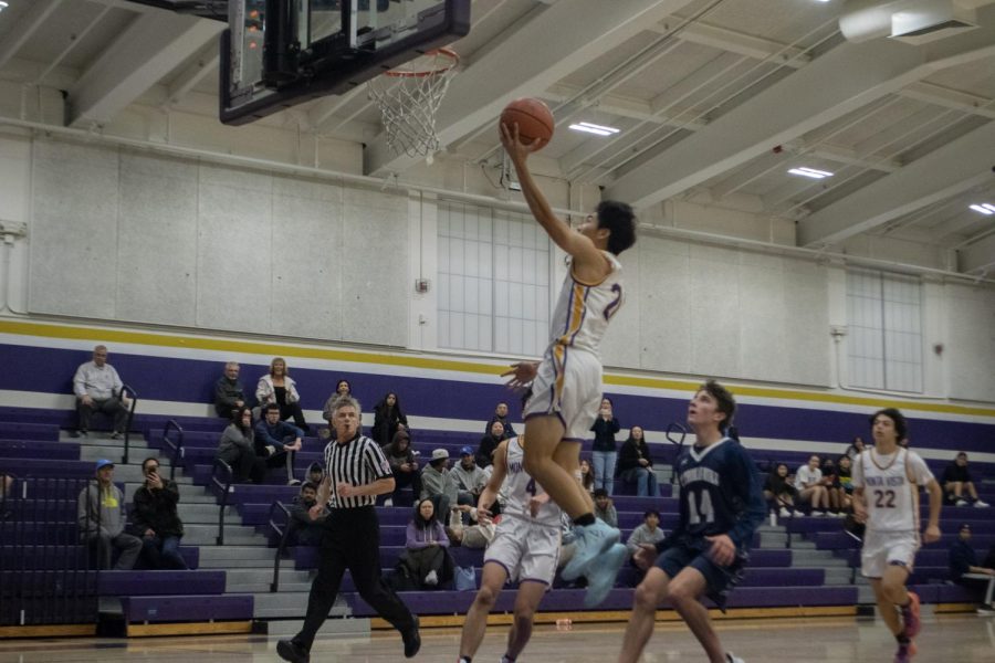 Sophomore Stanley Du springs into the air to score a layup. 