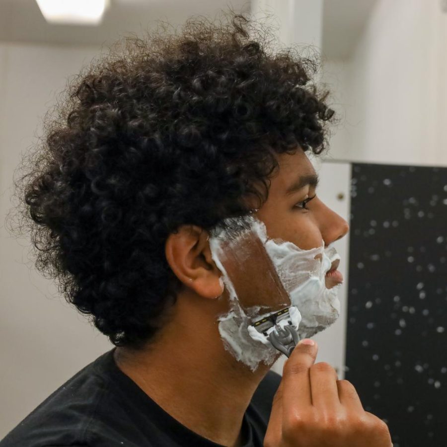 Senior Yash Thapliyal shaves as part of his daily routine.  Photo by Krish Dev