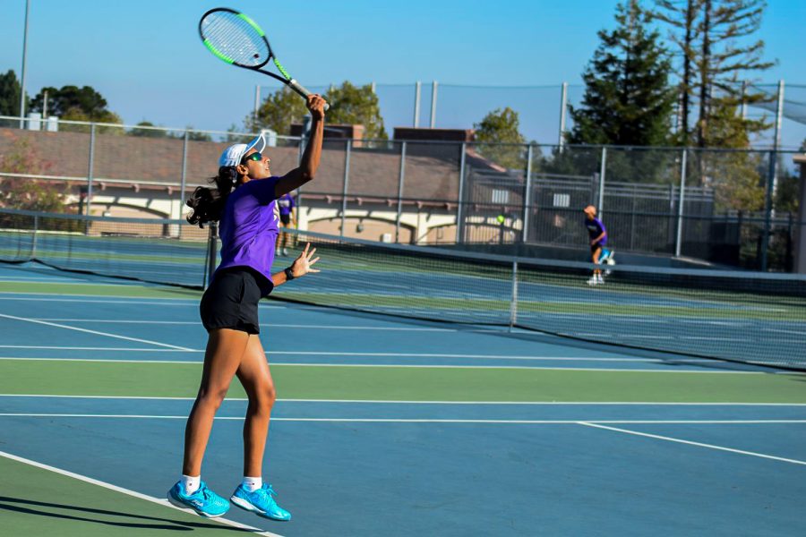 Junior and captain Himani Jha serves to her opponent during a game against Mountain View High School on Sept. 7, where the team won 4-3.