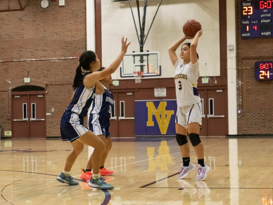 Senior Emi Kosakura searches for an opening to pass the ball over her opponents.