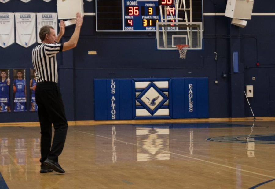 Basketball referee Scott Calvin calls a time out.