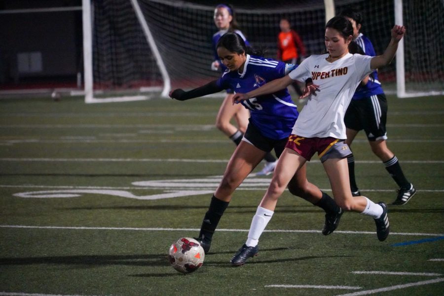 Senior and captain Ishita Pesati defends the ball from her opponent.