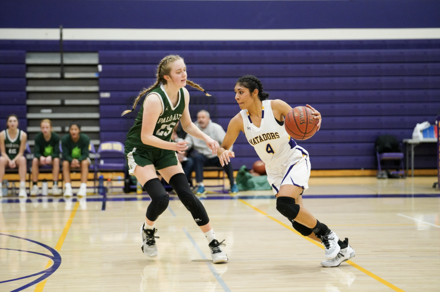 Senior Varshini Peddinti drives past an opponent in the Varsity Girls Basketball game against Palo Alto High School on Thursday, Jan. 12, which the team lost 54-45. The Matadors currently have a season record of 15-6.