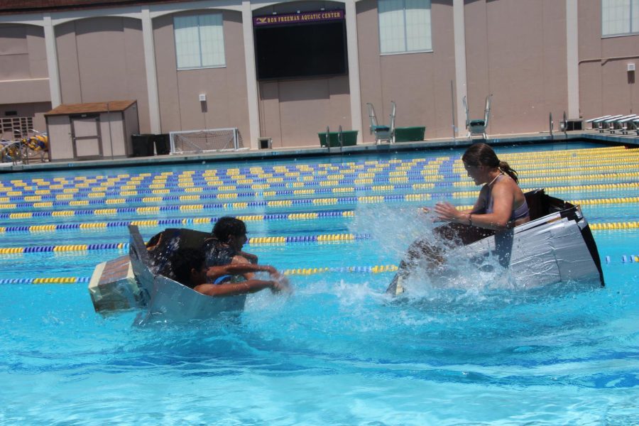 The seniors and freshmen splash each other in the hopes of sinking the others boat.