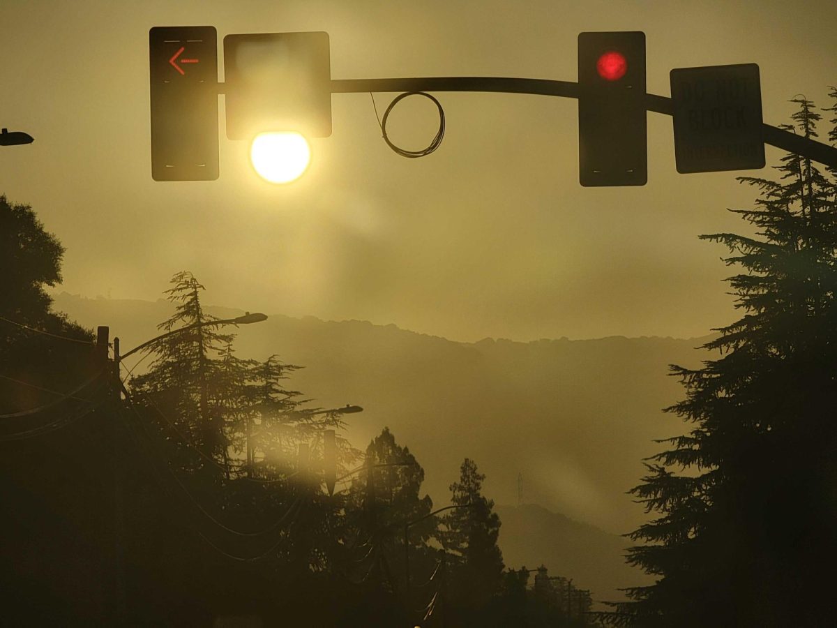 Smog blurs sunlight rays along a street near MVHS.