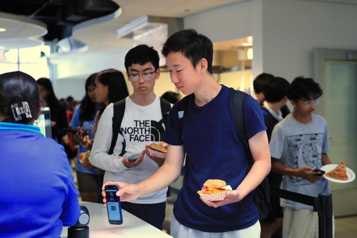 Junior Eric Zhou scans his ID using Minga at the lunch line.