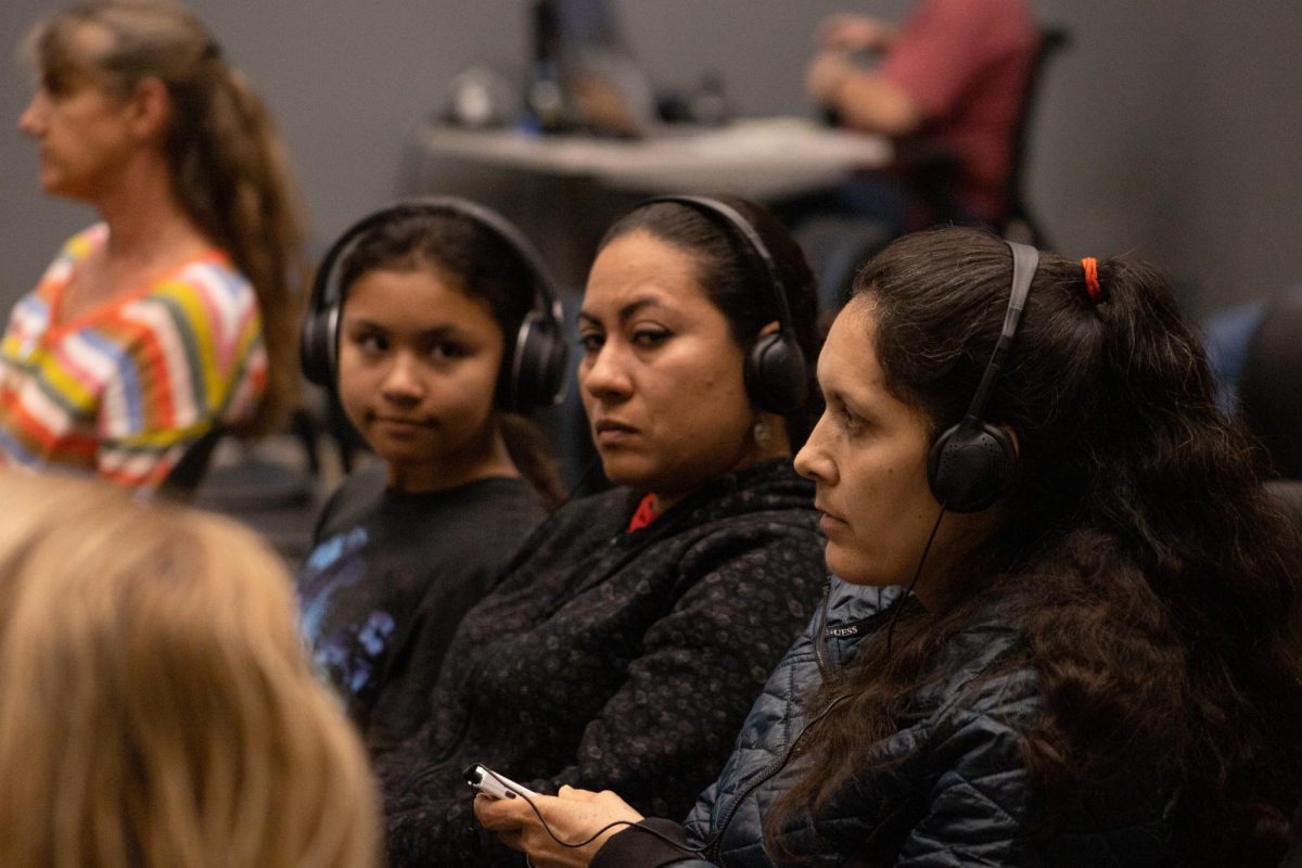 FUHSD parents Rosario Rivera and Claudia Camacho listen to a live Spanish translation during the Boards Sept. 19 pre-mapping public hearing.