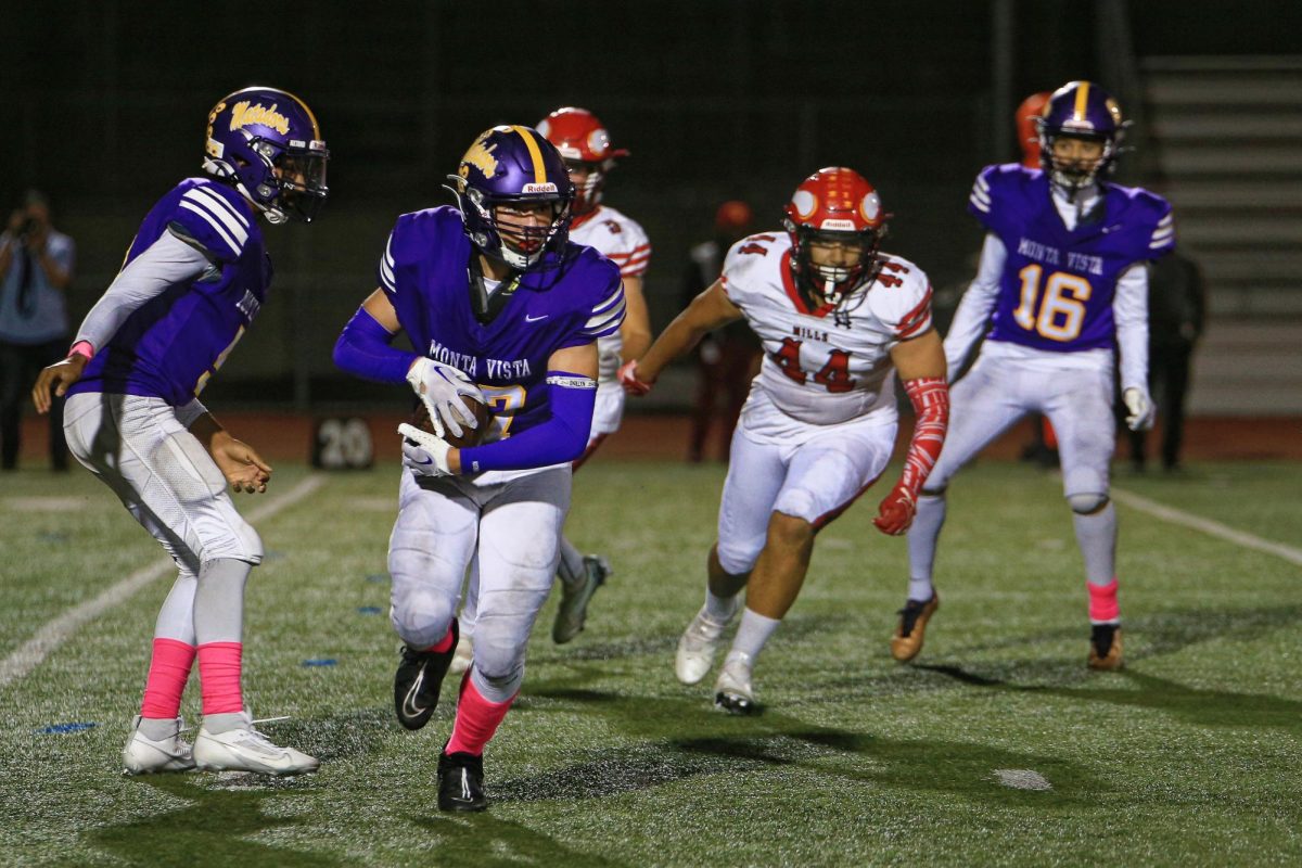 Sophomore and running back Graham Ischo runs with the ball as MHS lineman chase him.