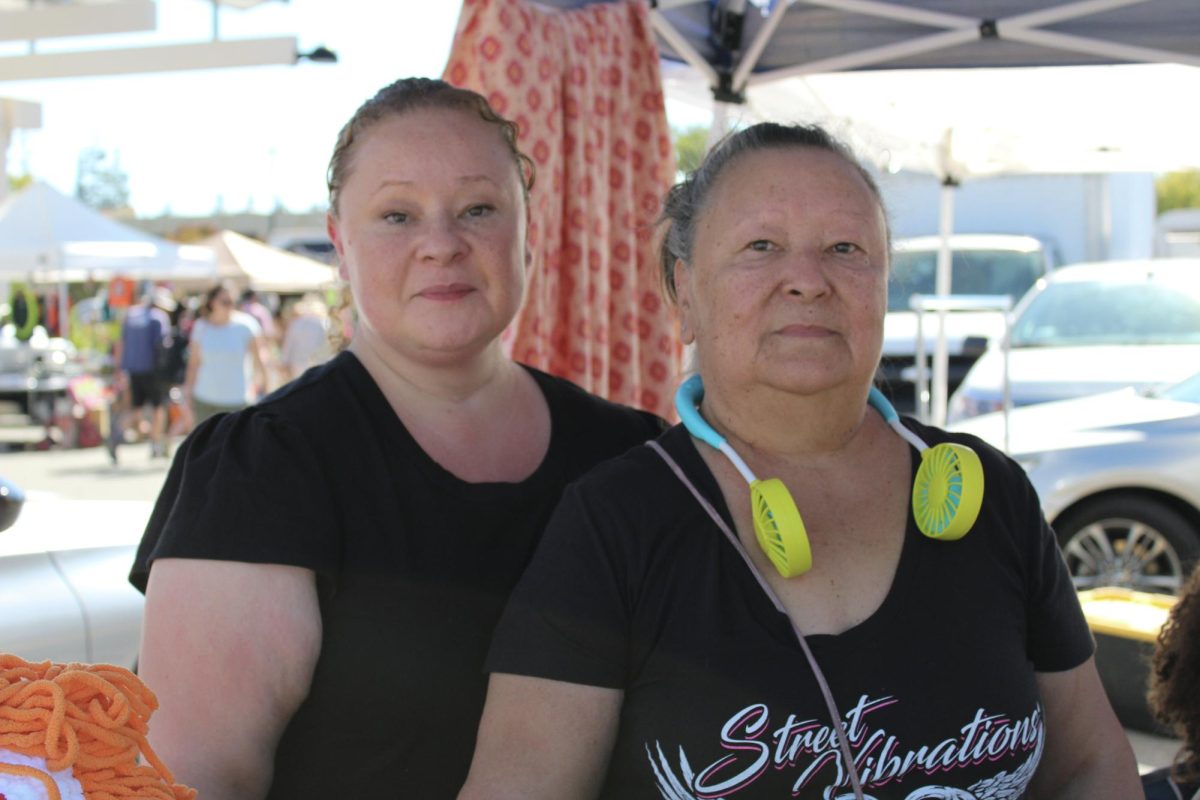 Malinda and Rosie Vargas (left and right, respectively) pose behind their booth at the De Anza Flea Market