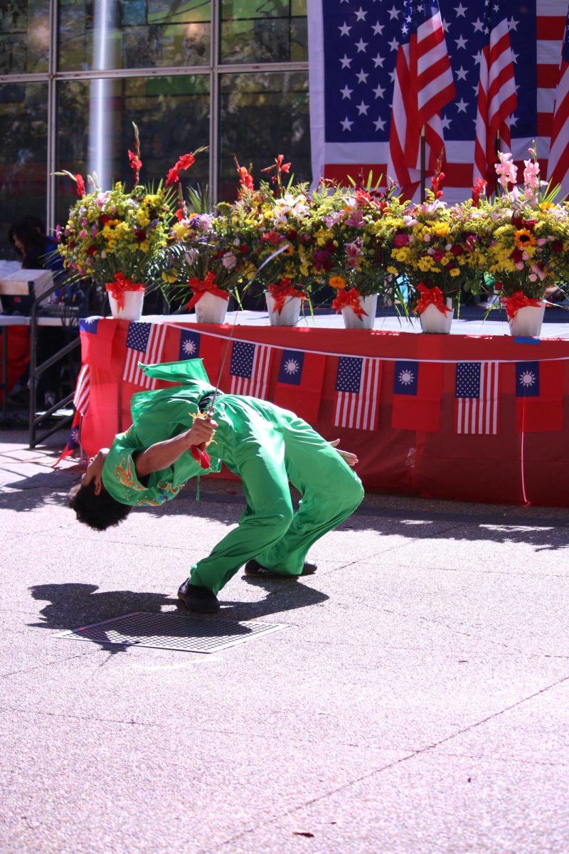 A performer executes a kip-up. 
