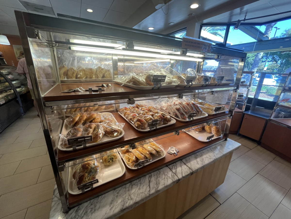 This display showcases some of the pastries in a wide variety of flavors along with other baked goods.