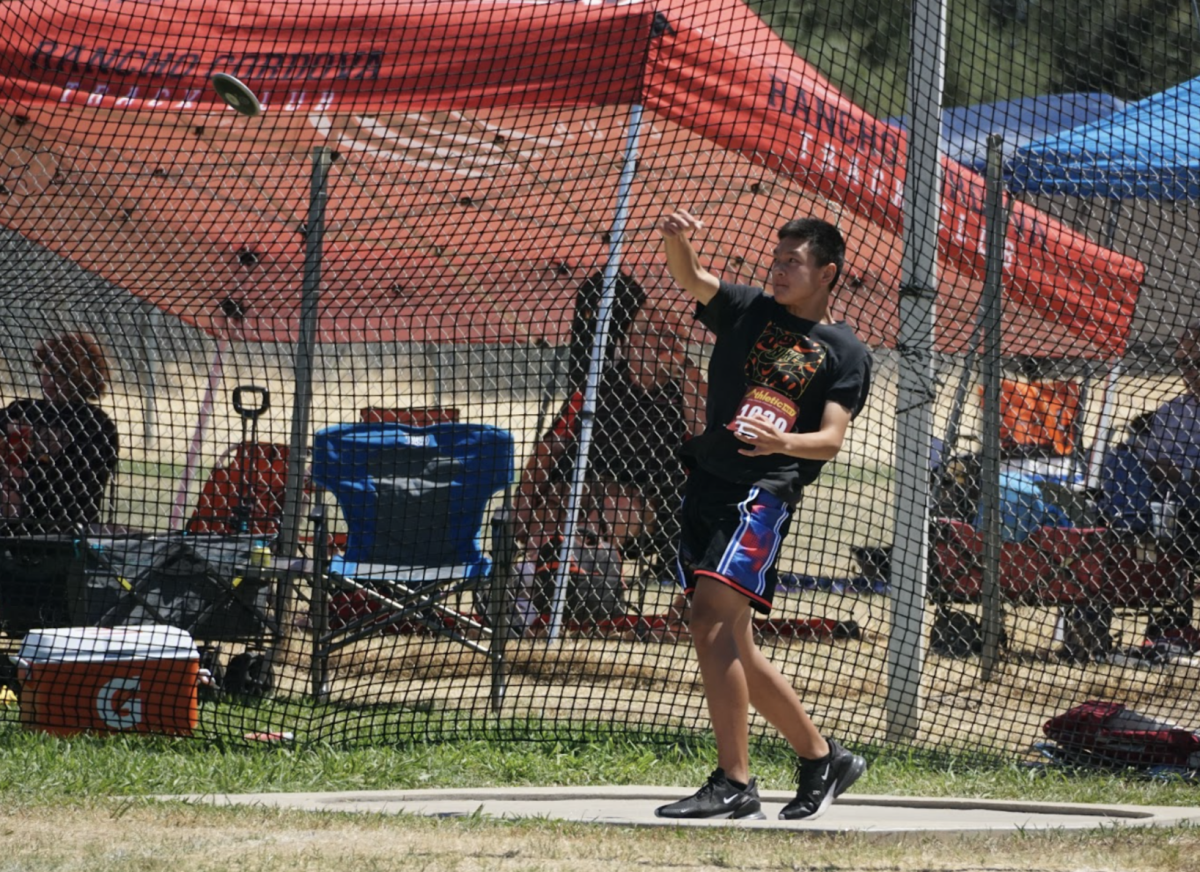 Freshman Edward Fan launches a discus using the force of a turn.