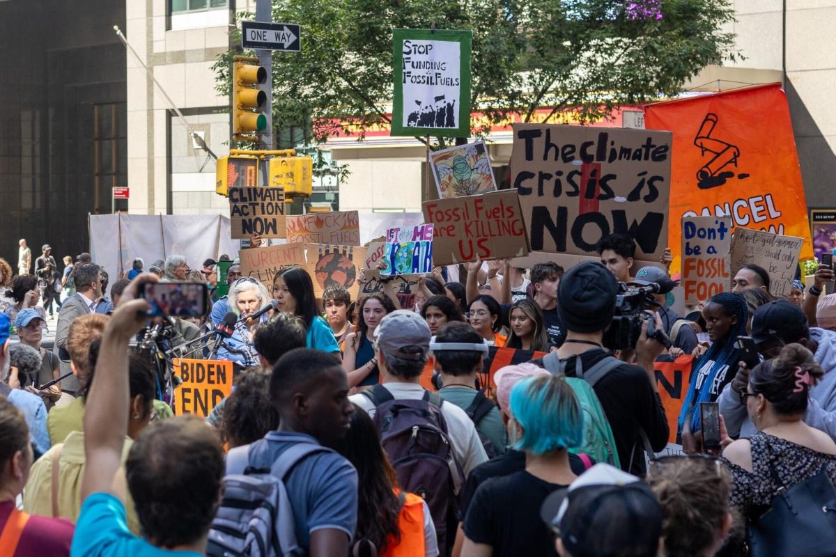 A climate protest takes place in New York City, urging action against fossil fuel emissions.